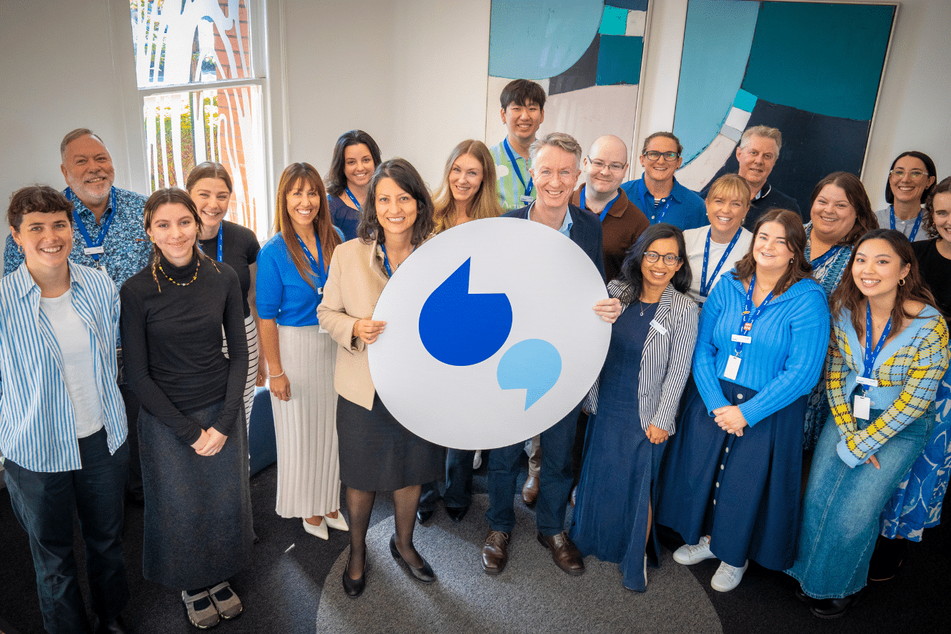Image of Diabetes Victoria staff holding the logo and smiling